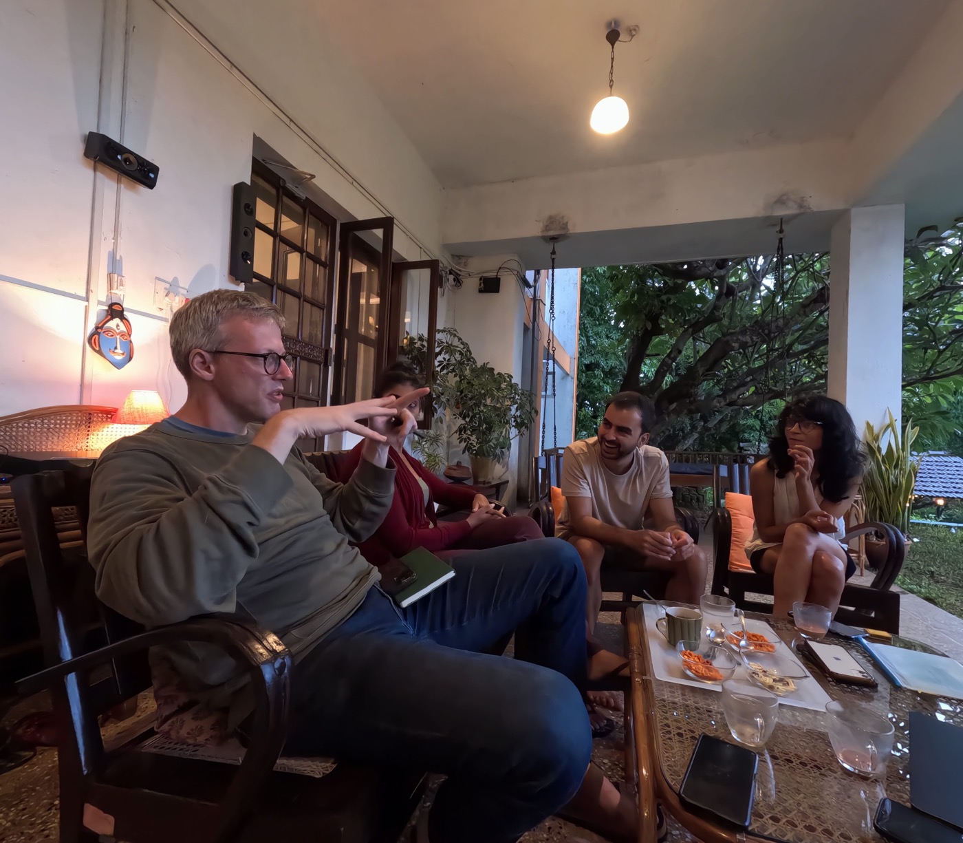 Residents in evening conversation on the veranda