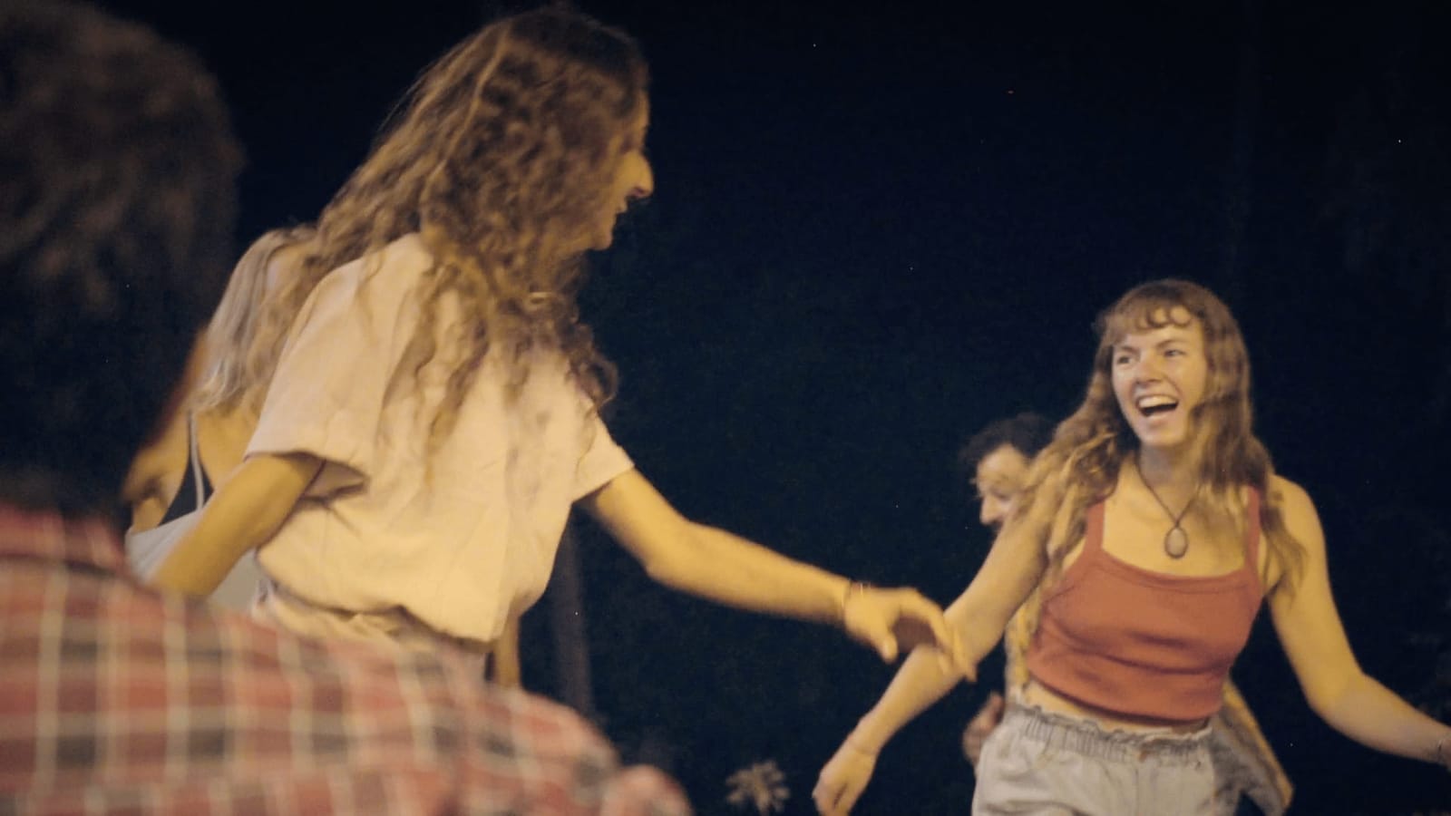 Two residents dancing and laughing together at night