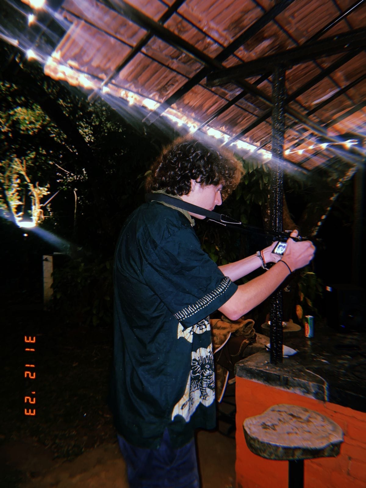 A musician playing guitar and singing at the night party