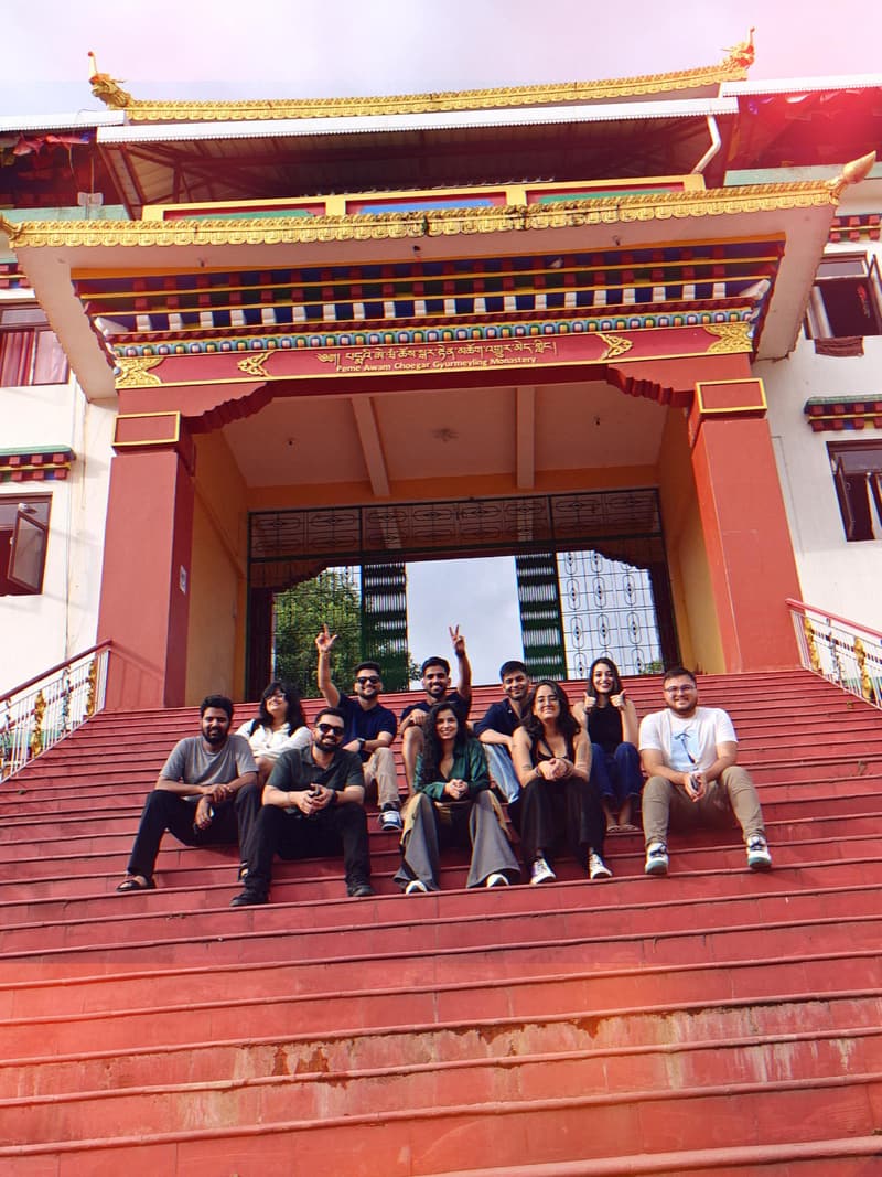 The Fanhouse community sitting together on red monastery steps